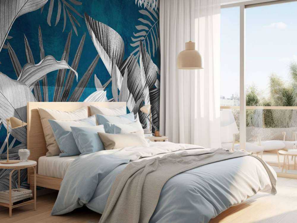 Feuilles tropicales sur fond bleu canard