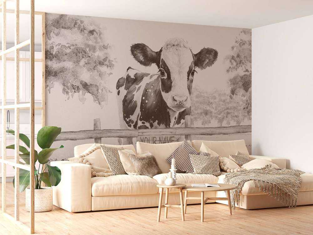 Bébé vache dans un pré beige