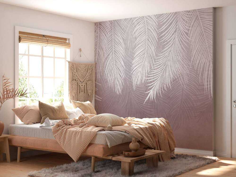 Feuilles de palmier sur un mur en béton