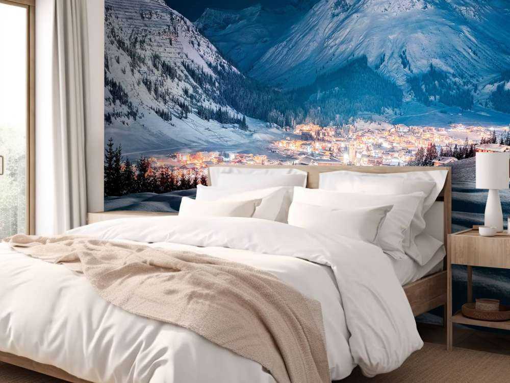 Village d'hiver sous la lumière de la lune dans une vallée alpine.