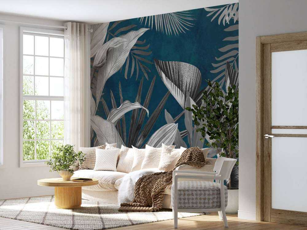 Feuilles tropicales sur fond bleu canard