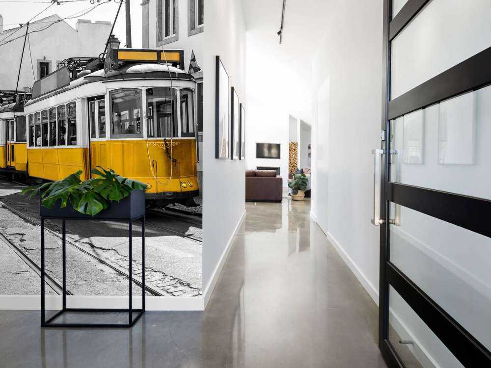 Tramway jaune dans une rue en noir et blanc