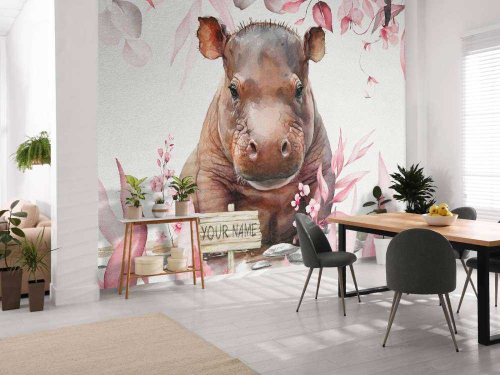 Bébé hippopotame dans les feuilles rose