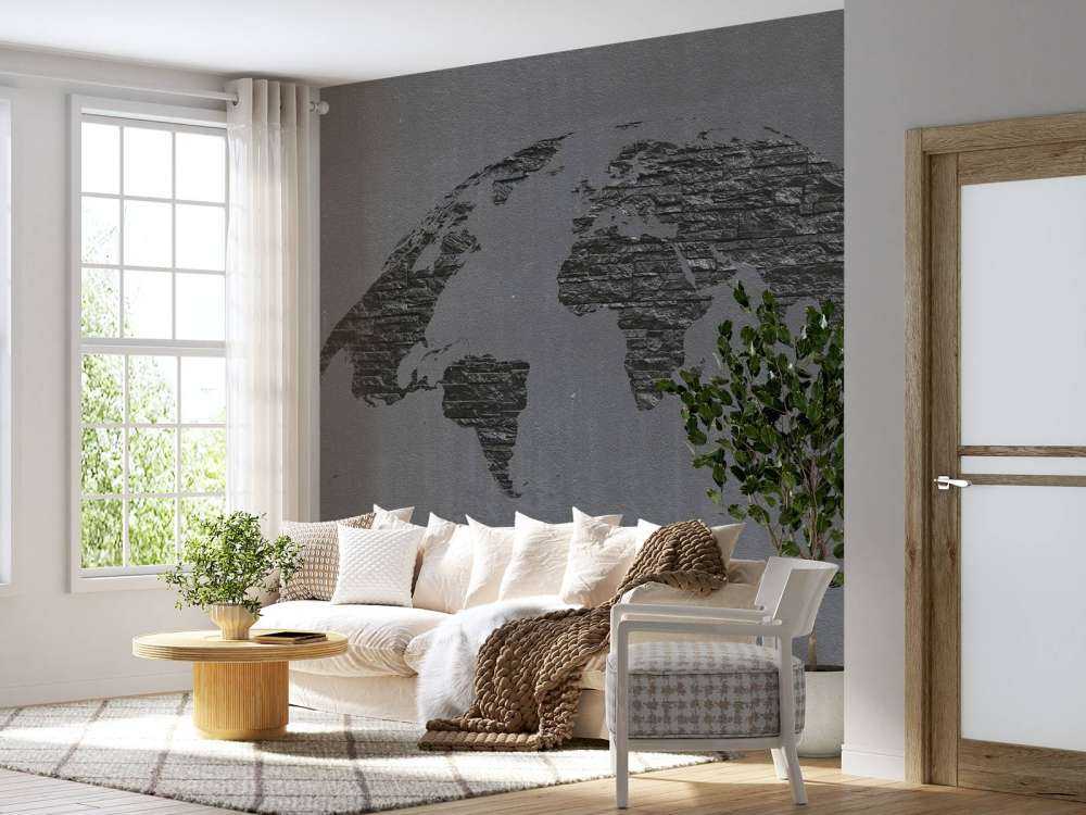 Pierres de la carte du monde sur du béton gris