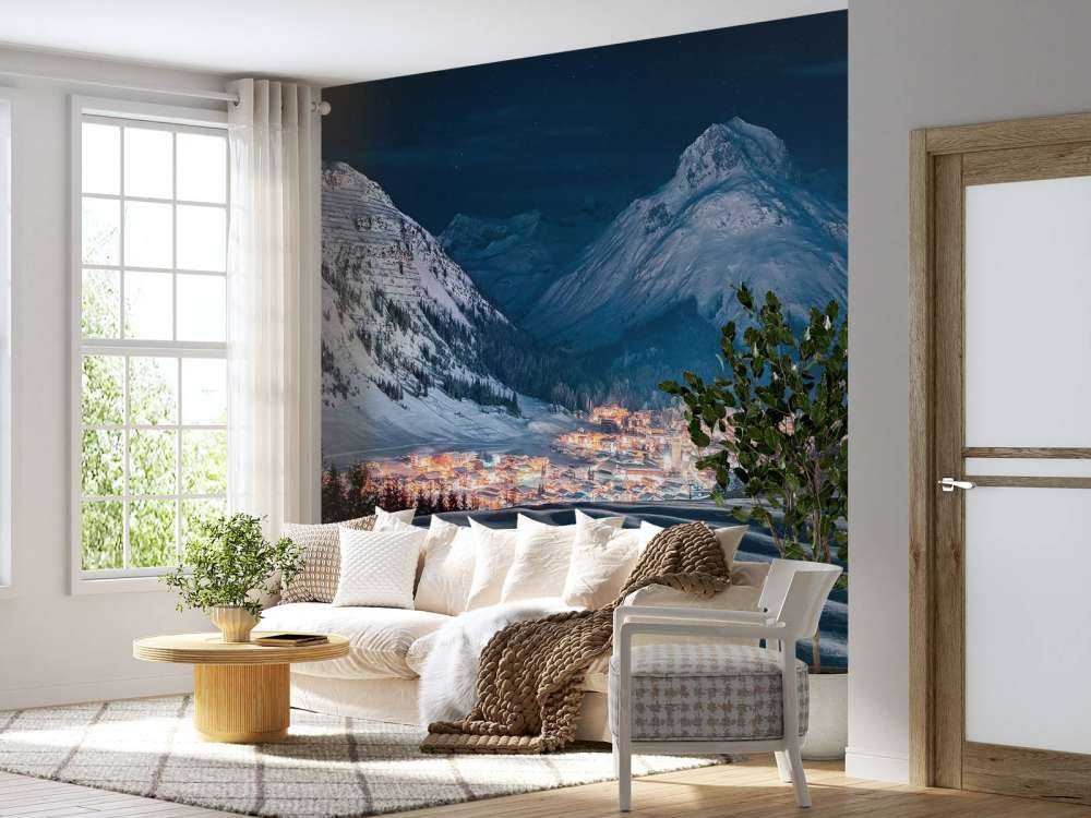 Village d'hiver sous la lumière de la lune dans une vallée alpine.